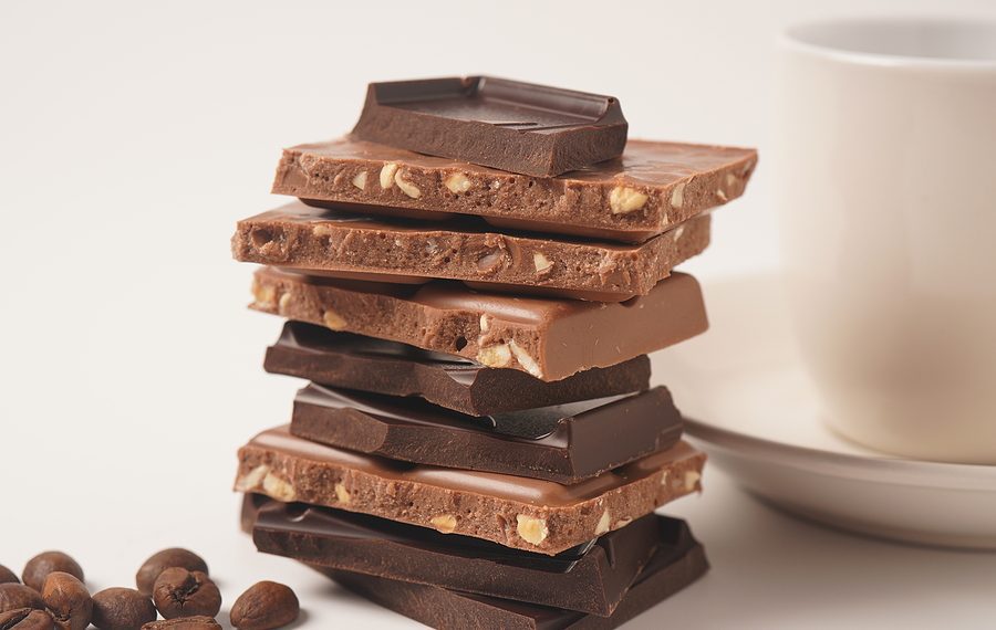 Chocolate tower. Stack of chocolate pieces. The chunks of broken chocolate. Background with chocolate.